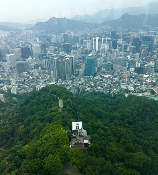 76 Delightful Things to do on a Rainy Day in Seoul (+ Heat and Pollution too!) 13 views of namsan mountain and seoul cityscape through the windows of the namsan cable car