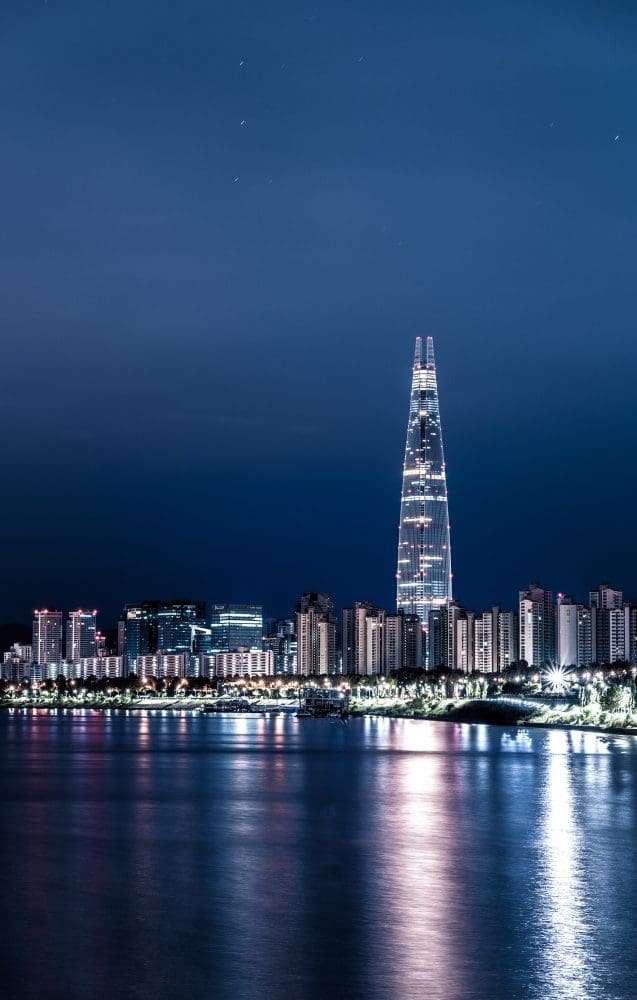 Seoul at Night | 29 Amazing Things for Insomniacs to do After Dark 43 lotte world tower next to the Han River and apartment buildings lit up in seoul at night