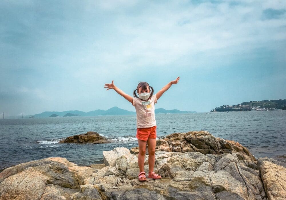 Maemiseong (매미성) | How to Visit Geoje's Magical Castle 7 girl on rock near Maemi Castle on Geoje Island